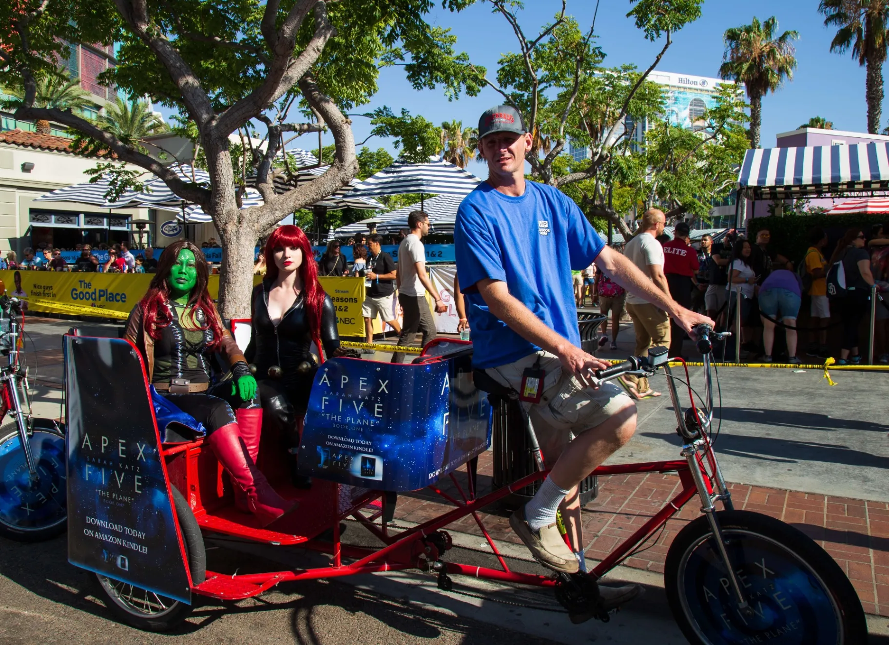Cosplayers posing with Apex Five branded pedicab at Comic-Con