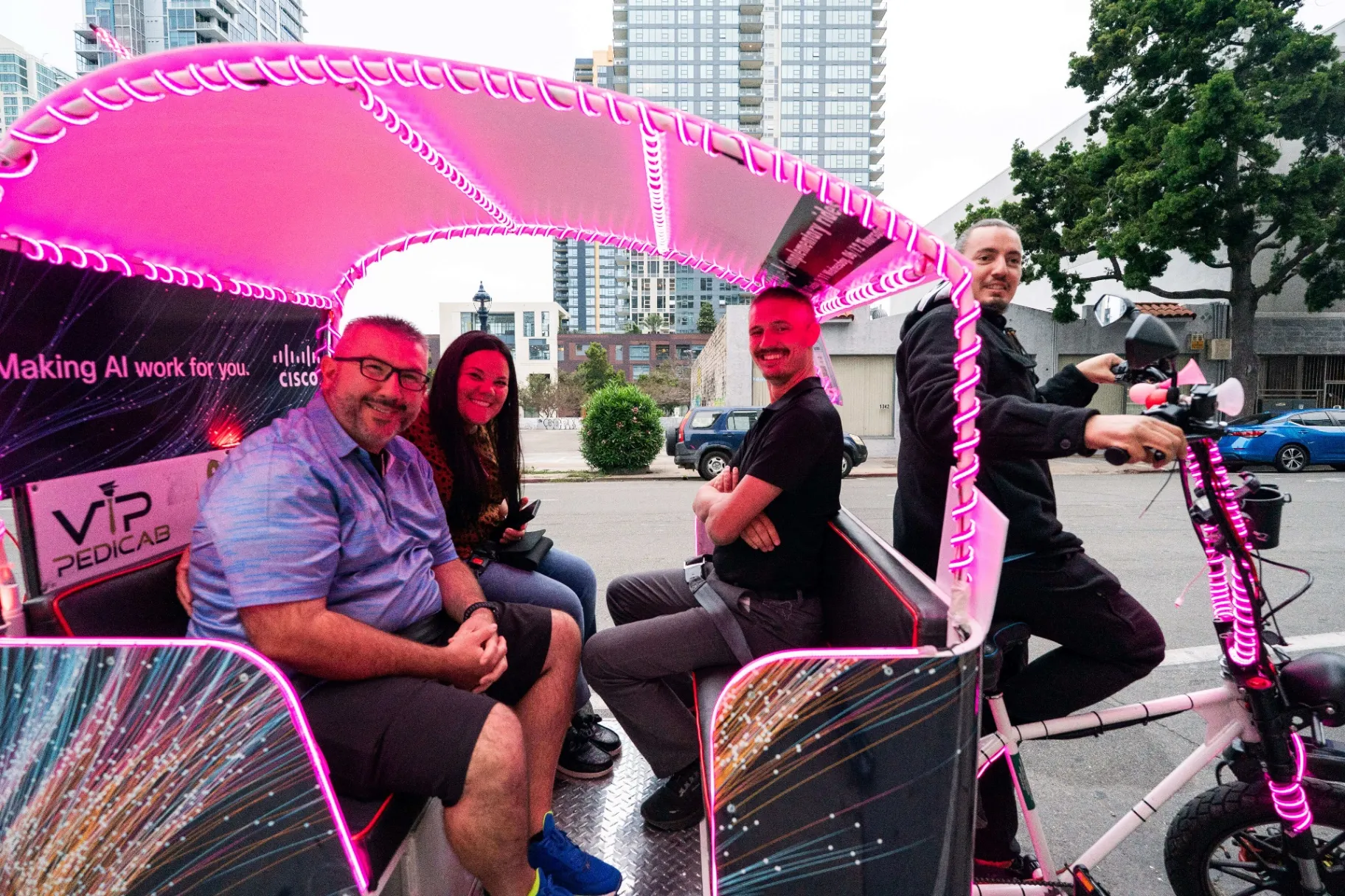 Cisco Live attendees enjoying an evening pedicab ride with pink LED lights