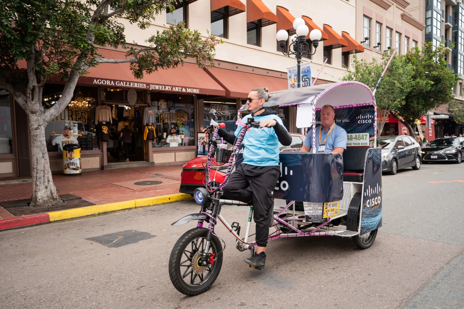 Pedicab carrying Comic-Con attendees through San Diego's Gaslamp Quarter near the Convention Center