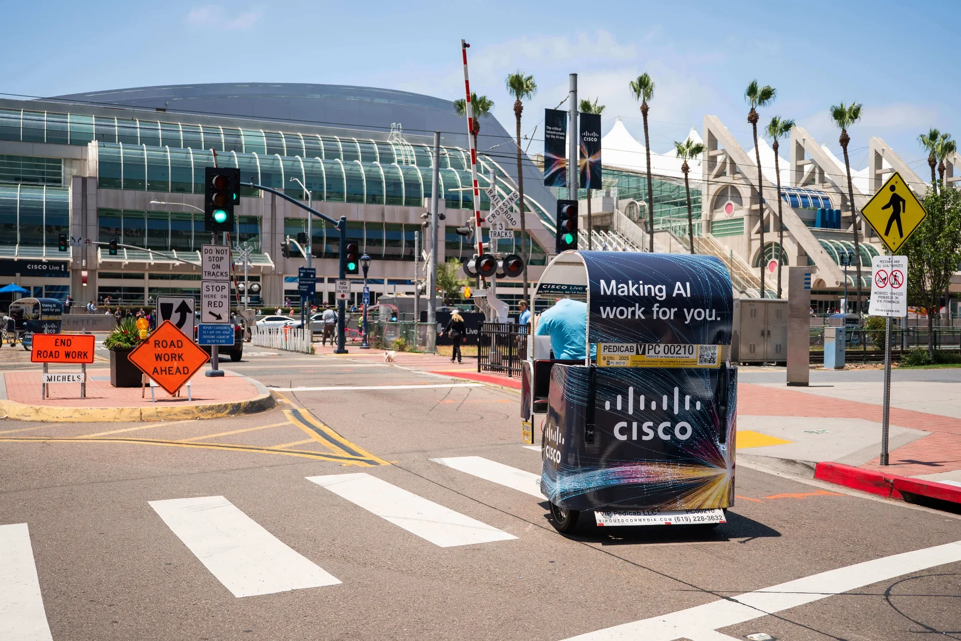 Cisco branded pedicab crossing intersection near San Diego Convention Center during Cisco Live