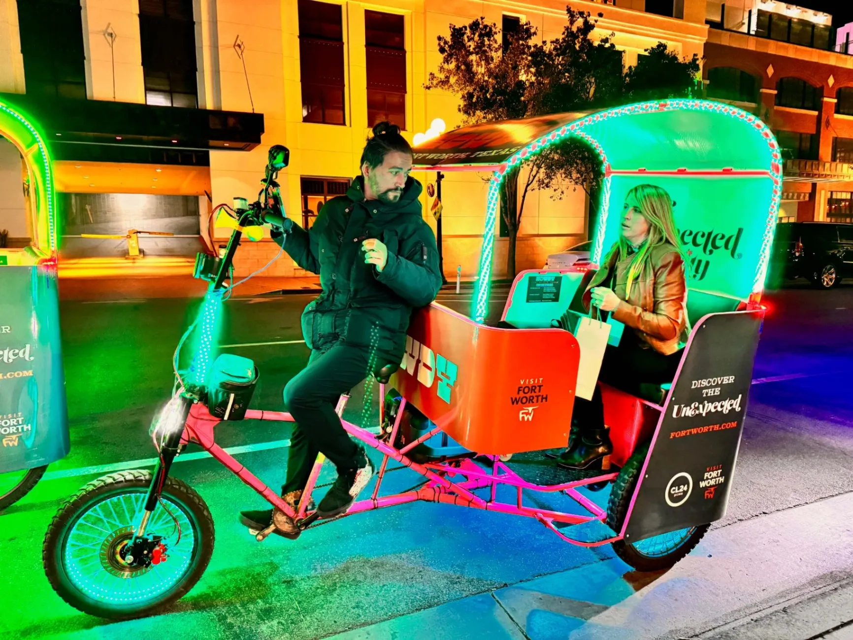 Visit Fort Worth branded pedicab with green LED lights at night in San Diego