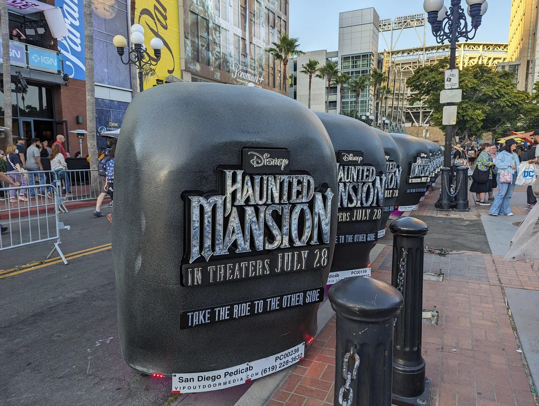 Fleet of custom Haunted Mansion Doom Buggy pedicabs lined up in Gaslamp Quarter during SDCC 2023