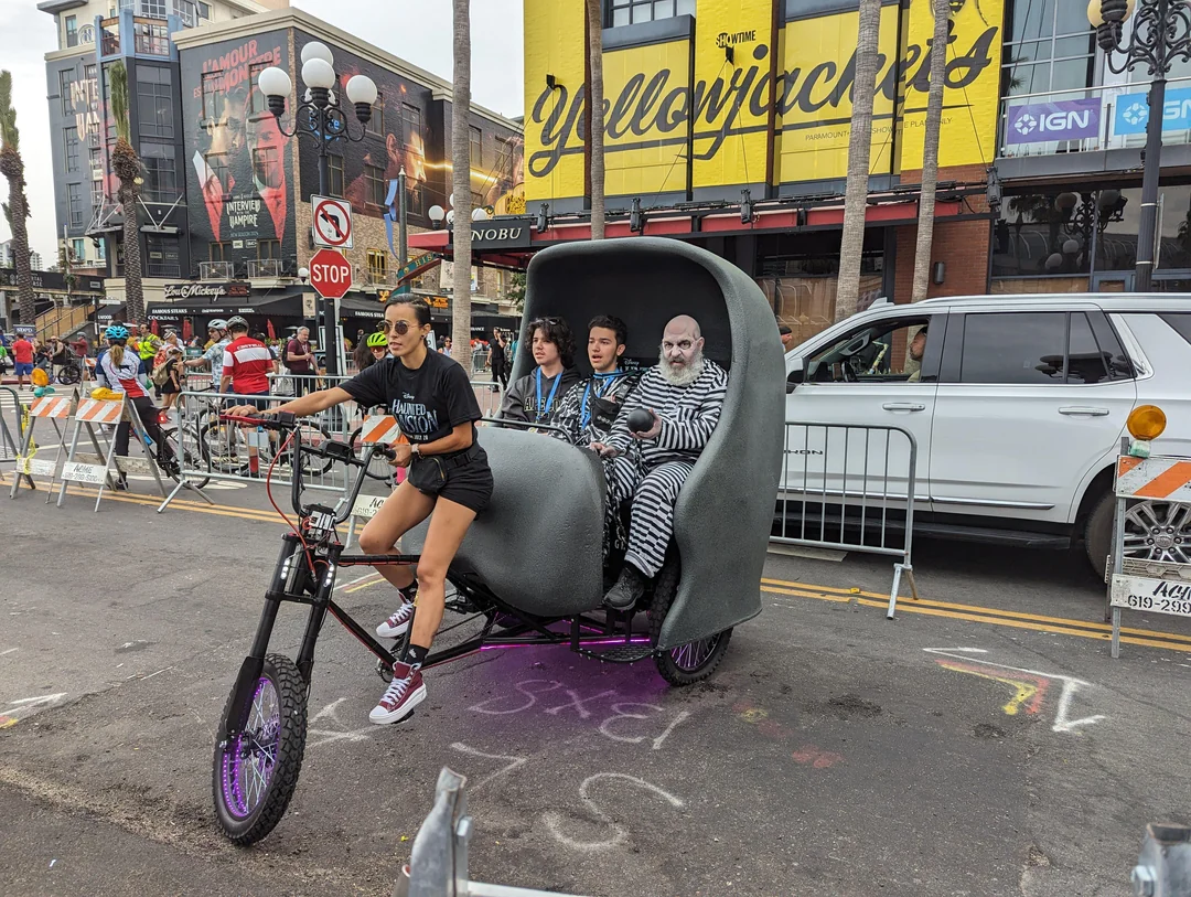 Disney Haunted Mansion branded pedicab with blue ambient lighting cruising through San Diego