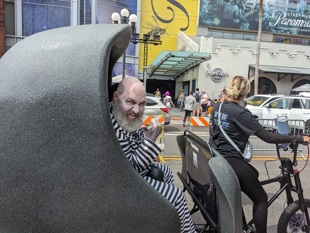 Hitchhiking Ghost actor surprising Haunted Mansion pedicab passengers at Comic-Con 2023