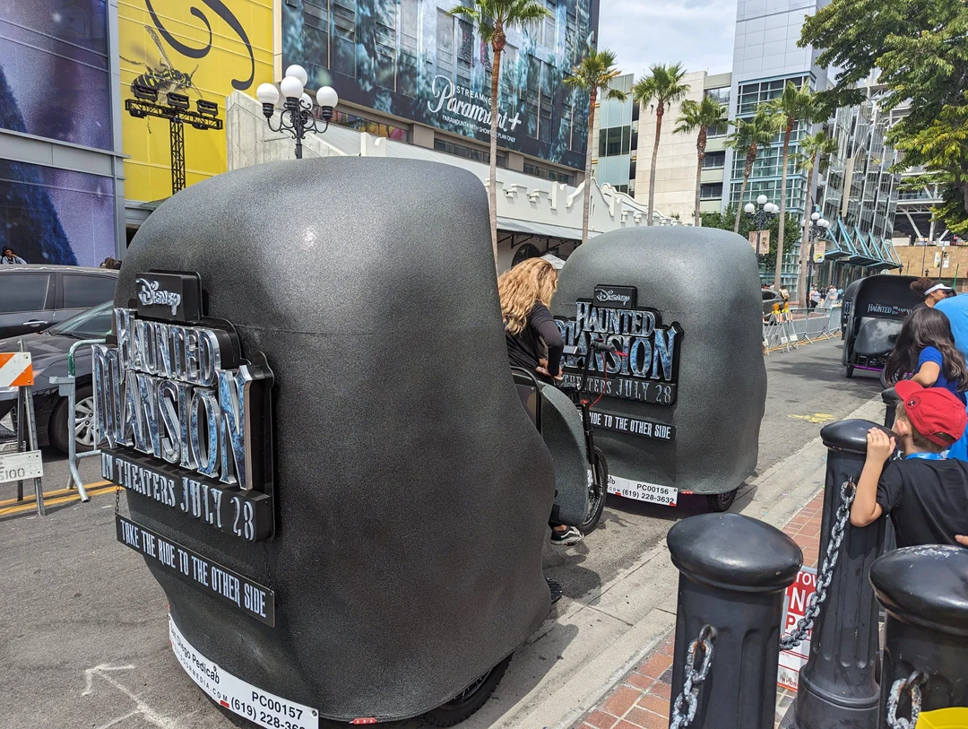 Disney Haunted Mansion pedicab branding close-up with movie poster art at Comic-Con