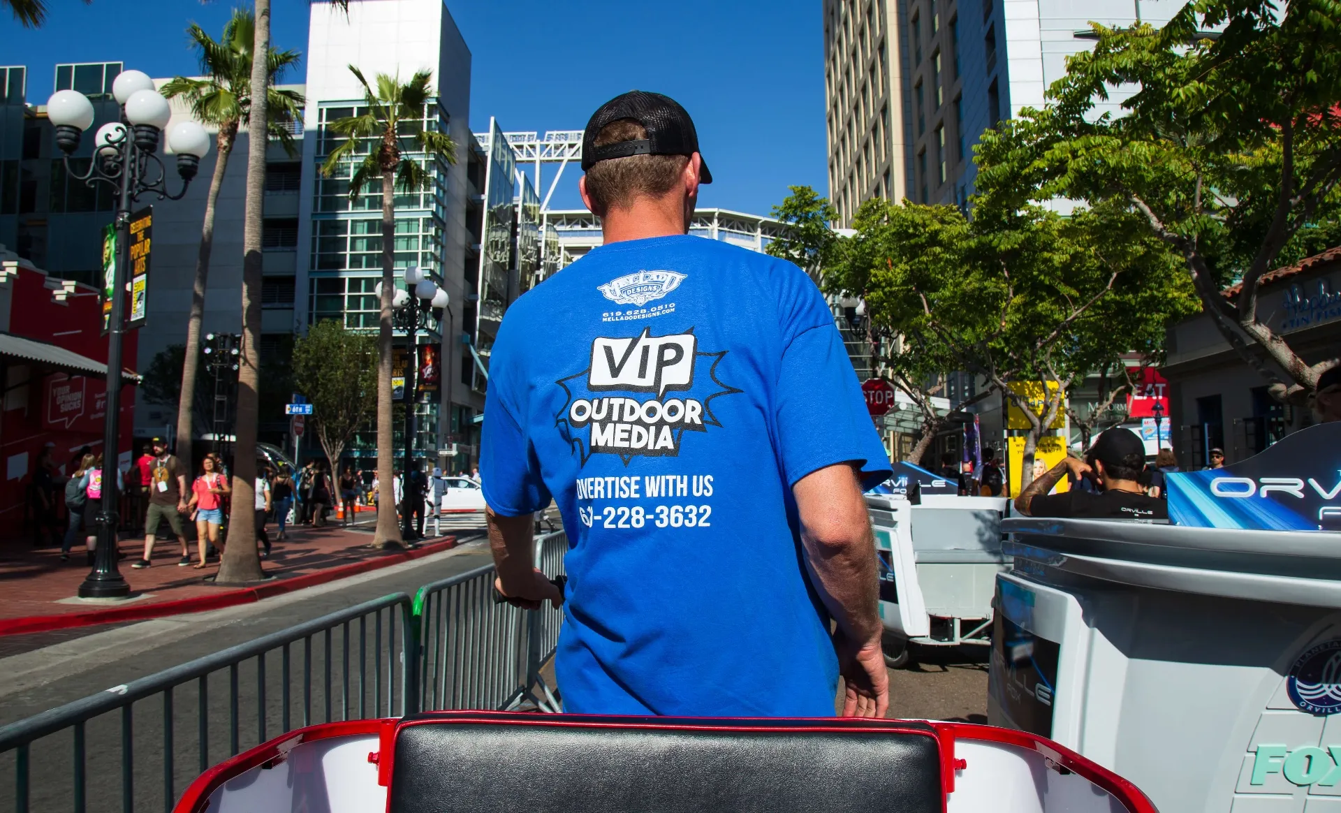 VIP team member leading Orville and Apex campaign pedicab with cosplayers at Comic-Con