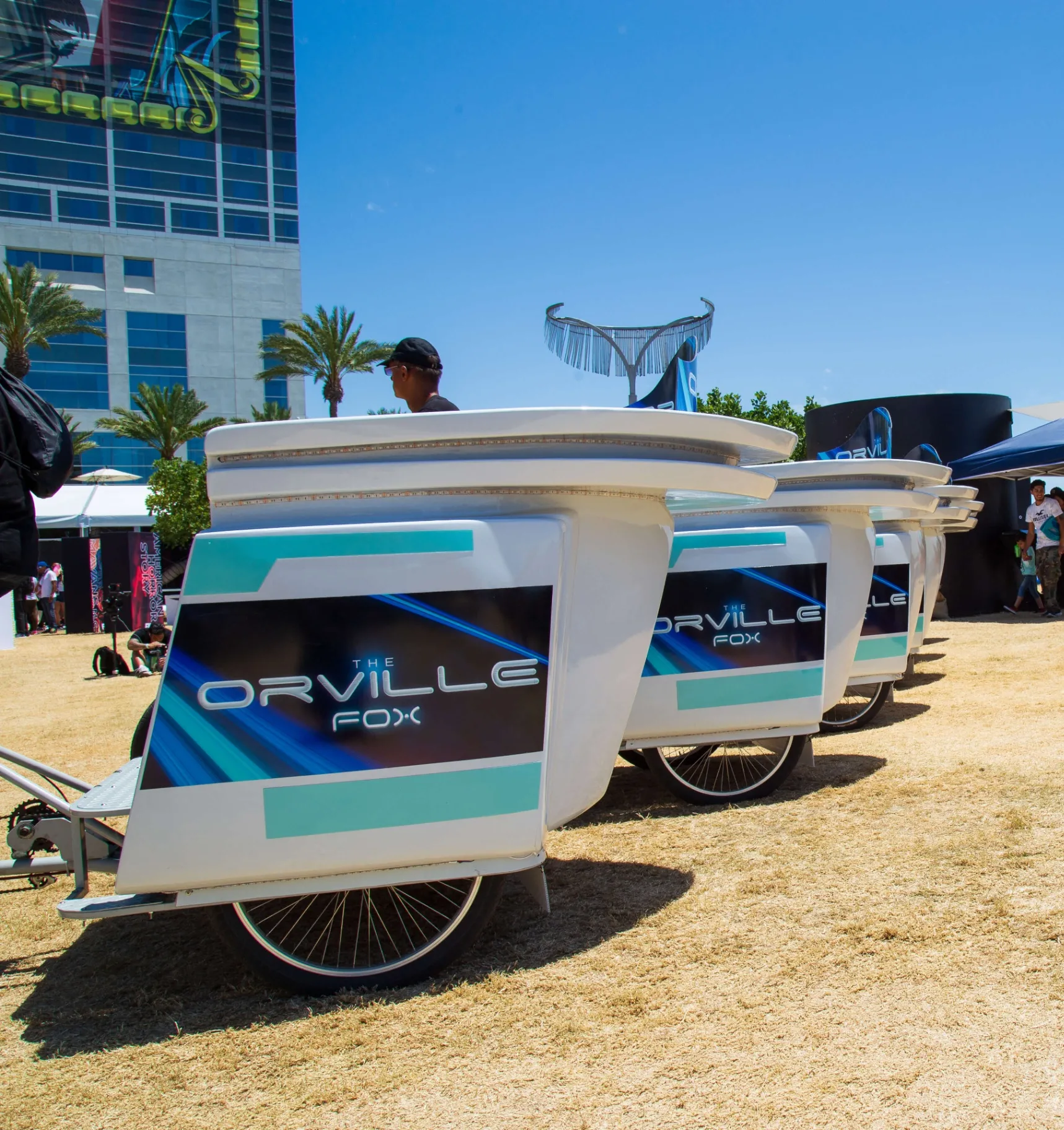 Orville branded pedicab line parked at COSMOS activation field