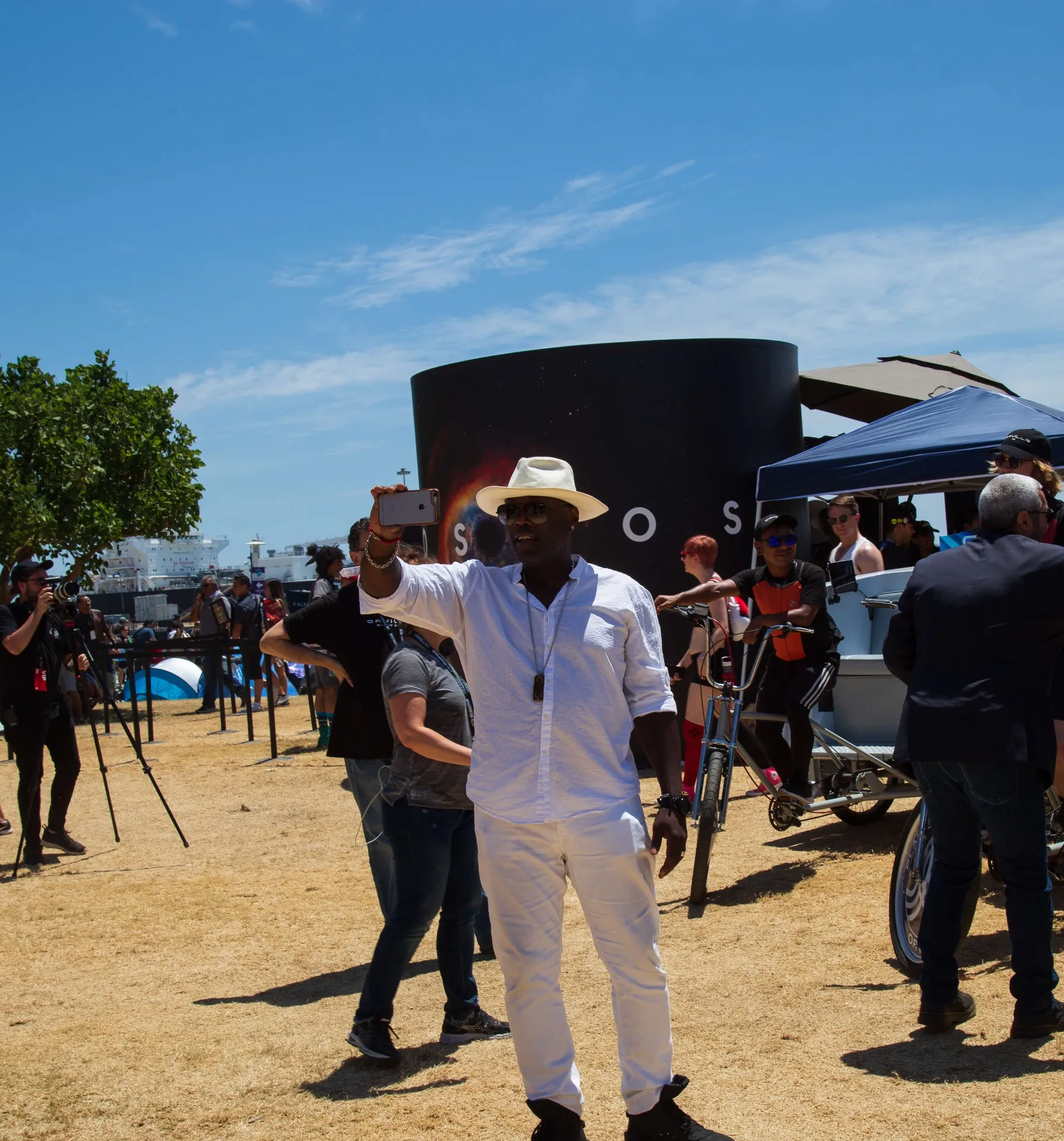 Guest filming content at COSMOS activation with Orville pedicabs nearby
