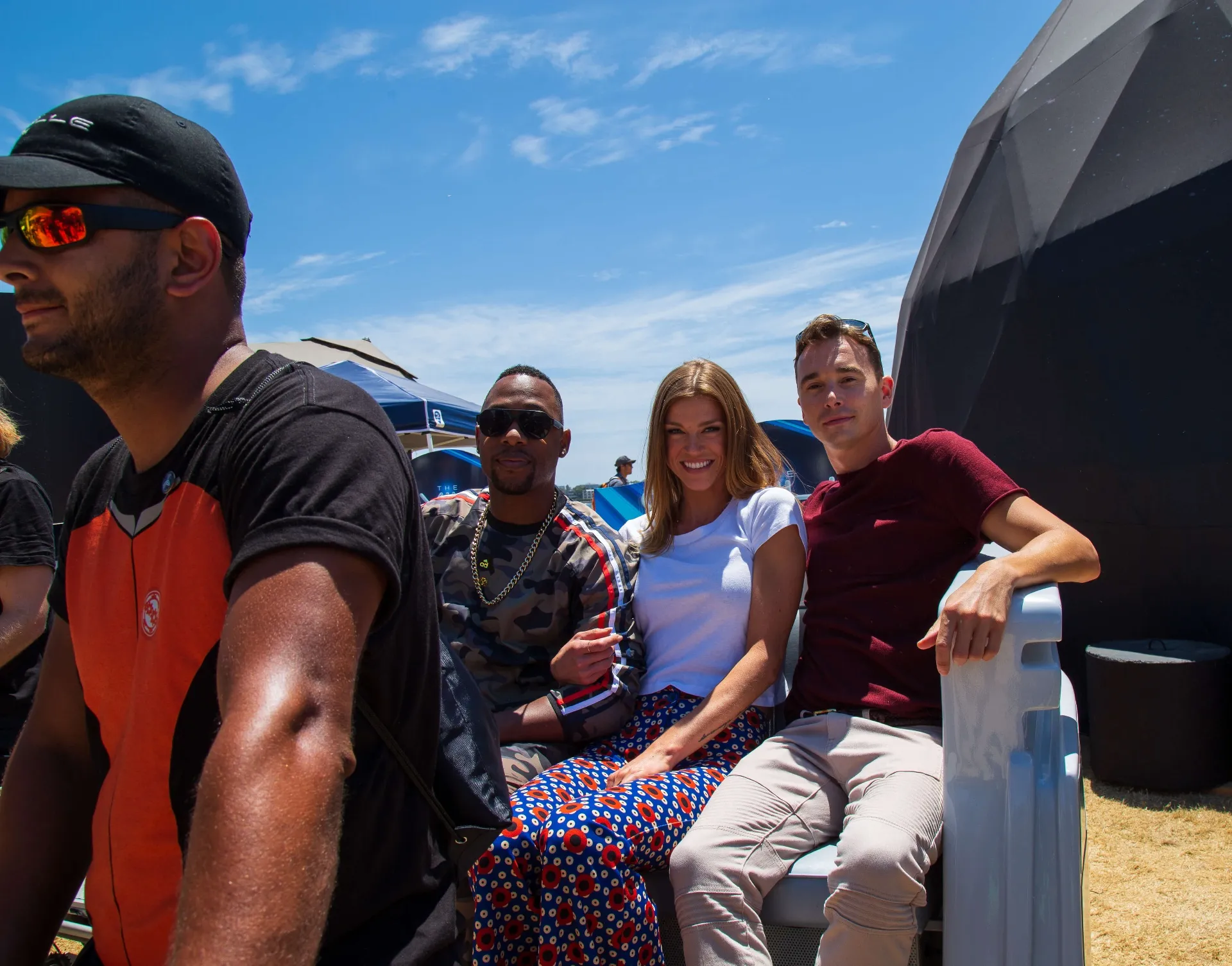 Close-up portrait of riders in Orville pedicab at COSMOS activation