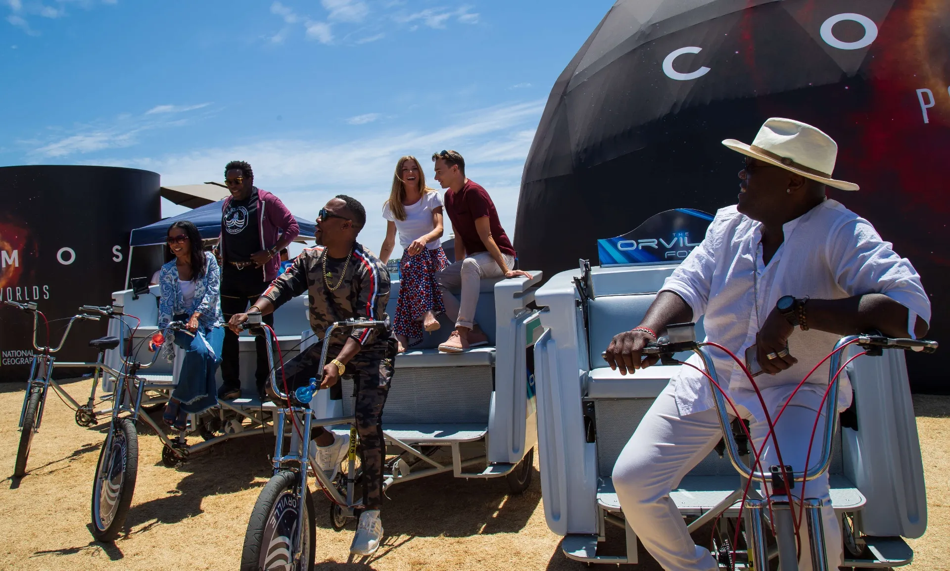 Team and guests gathered on Orville pedicabs at COSMOS activation