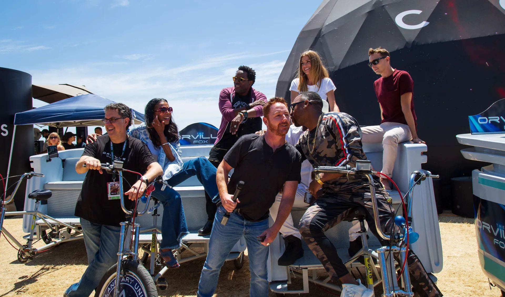Orville cast with Scott Grimes on pedicabs at COSMOS dome Comic-Con